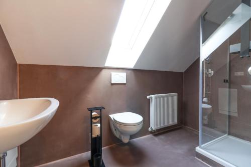 a bathroom with a sink and a toilet and a shower at Velura Apartments Stilvoll in Lauffen am Neckar