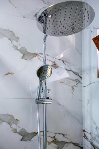 a shower head in a bathroom with astitialstitialstitialstitialstitialstitialstitialstitial at Riian Luxury Apartments in Ulcinj