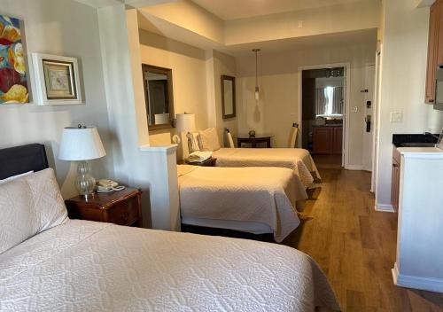 a hotel room with three beds in a room at The Point Hotel & Suites - 705H Luxury - Pool view - Close to Universal in Orlando