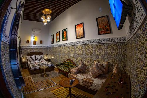 a living room with a couch and a table at Riad Hikaya - Fes Story in Fès