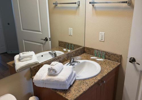 a bathroom with a sink and a mirror at The Point Hotel & Suites - 705H Luxury - Pool view - Close to Universal in Orlando