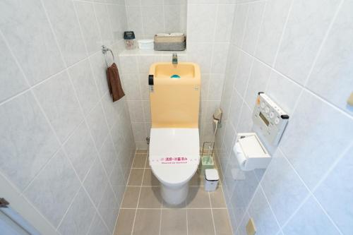 a small bathroom with a toilet in a stall at -3F - Vacation STAY 19502 in Uruma