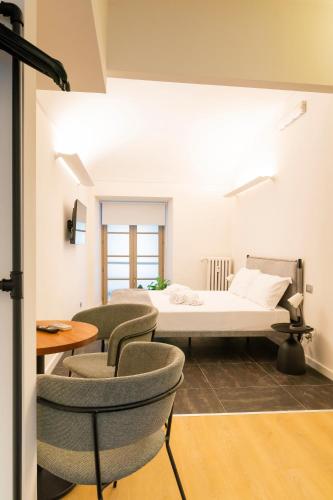 a room with a bed and chairs and a table at Turin Central Carlo Felice in Turin