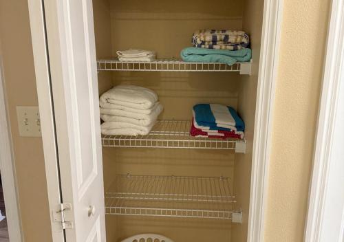 a walk in closet with towels and towels at The Point Hotel & Suites - 705S Luxury - Pool view - Close to Universal in Orlando