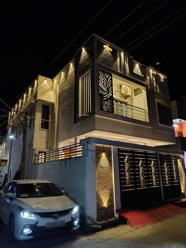 a car parked in front of a building at night at THE VILLA Pondicherry in Puducherry