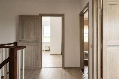a hallway with an open door to a room at 1 House Between Two Lakes in Vilnius