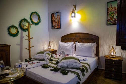 two twin beds in a room with christmas decorations at Riad Hikaya - Fes Story in Fès