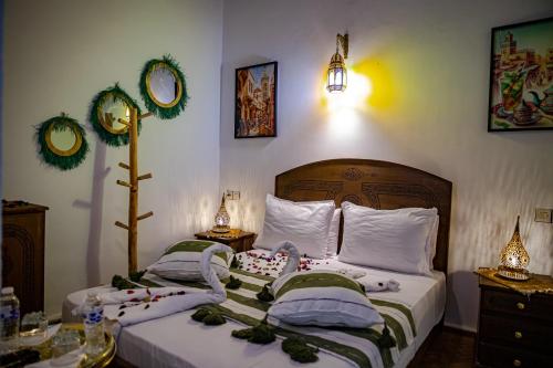 two twin beds in a bedroom with decorations on them at Riad Hikaya - Fes Story in Fès