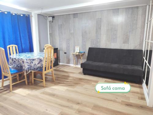 a living room with a table and a couch at Casa con terraza puerto montt in Puerto Montt