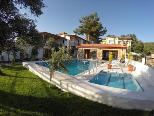 a swimming pool in the yard of a house at Pınar Vintage House in Pamukkale
