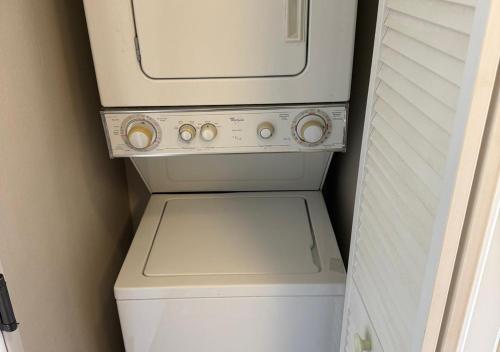 a white washer and dryer in a bathroom at The Point Hotel Apartment 603 Near to Universal in Orlando