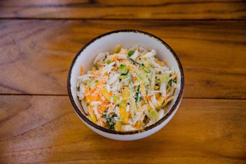 a bowl of coleslaw on a wooden table at Oceans Edge Key West in Key West