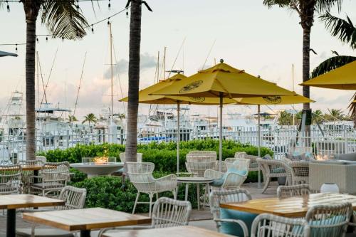 an outdoor patio with tables and chairs and umbrellas at Oceans Edge Key West in Key West
