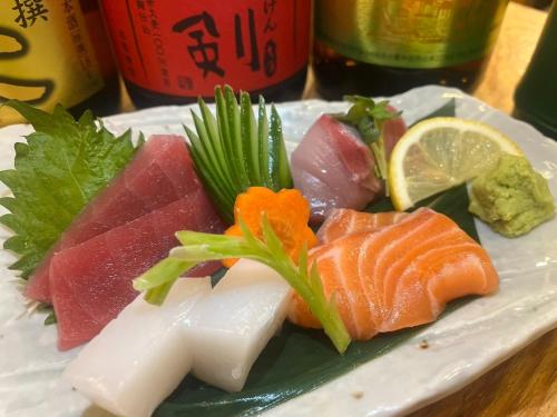 a plate of food with sushi on a table at Silver Heights 3rd floor 302,303,304 - Vacation STAY 65741v in Osaka