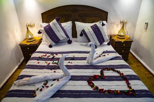 a bed with two swans made to look like hearts at Riad Hikaya - Fes Story in Fès