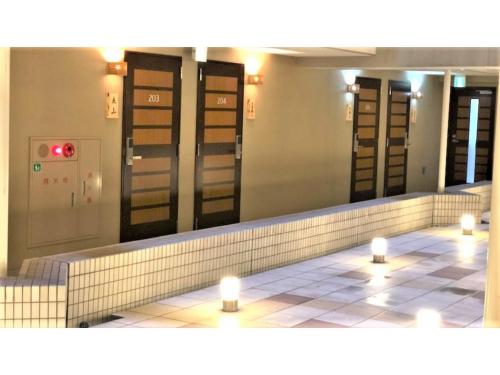 a row of stalls in a bathroom with a mirror at Smile Hotel Nagoya Sakae - Vacation STAY 66704v in Nagoya