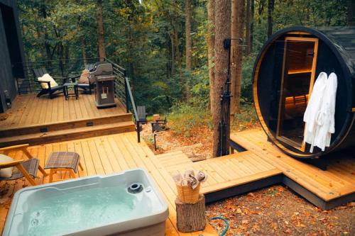 a tub on a wooden deck in the woods at Idyll Reserve - Hocking Hills in South Bloomingville