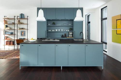 a kitchen with blue cabinets and a sink at Idyll Reserve - Hocking Hills in South Bloomingville