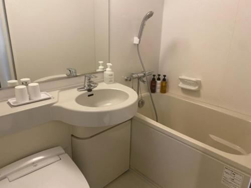a bathroom with a sink and a toilet and a shower at Smile Hotel Nagoya Sakae - Vacation STAY 66744v in Nagoya
