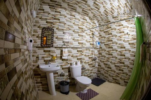 a small bathroom with a toilet and a sink at Riad Hikaya - Fes Story in Fès