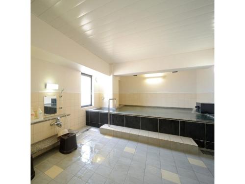 an empty bathroom with a toilet and a sink at Smile Hotel Yonezawa - Vacation STAY 67001v in Yonezawa