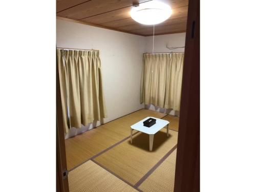 an empty room with a table and curtains at HANAMIDORI Oppara no Yado - Vacation STAY 67865v in Gujo