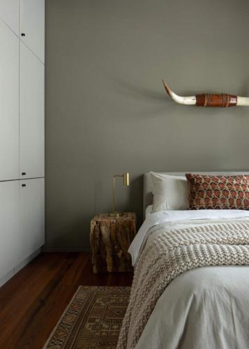 a white bedroom with a bed and a table at Idyll Reserve - Hocking Hills in South Bloomingville