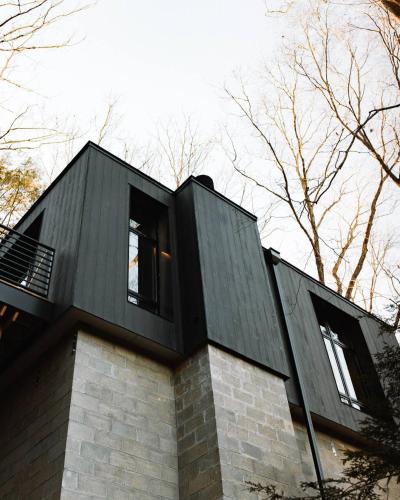 a black house with two windows on top of it at Idyll Reserve - Hocking Hills in South Bloomingville