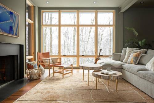 a living room with a couch and a large window at Idyll Reserve - Hocking Hills in South Bloomingville