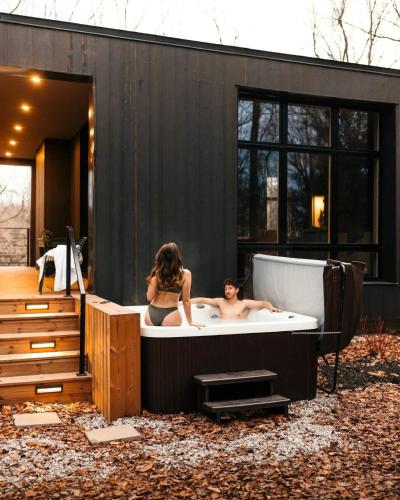 two people in a bath tub in a backyard at Idyll Reserve - Hocking Hills in South Bloomingville