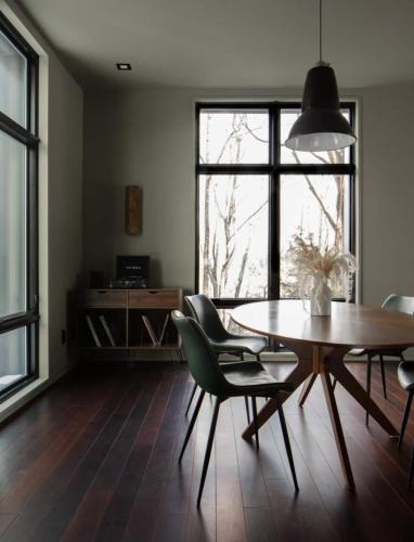 a dining room with a table and chairs and a window at Idyll Reserve - Hocking Hills in South Bloomingville
