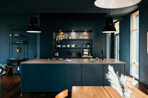 a kitchen with blue cabinets and a counter top at Idyll Reserve - Hocking Hills in South Bloomingville