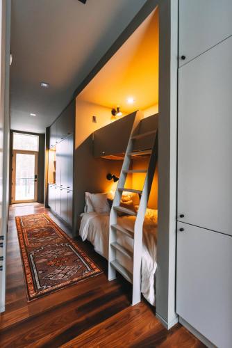 a bedroom with a bunk bed with a staircase at Idyll Reserve - Hocking Hills in South Bloomingville