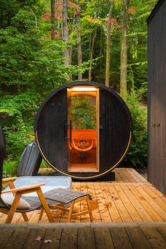 a circular pod is sitting on a wooden deck at Idyll Reserve - Hocking Hills in South Bloomingville