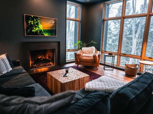 a living room with a couch and a fireplace at Idyll Reserve - Hocking Hills in South Bloomingville