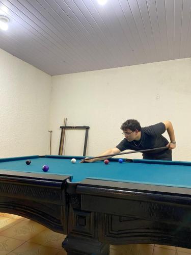 a man standing next to a pool table at 02- Cachoeiras do Pinga, Tianguá in Tianguá