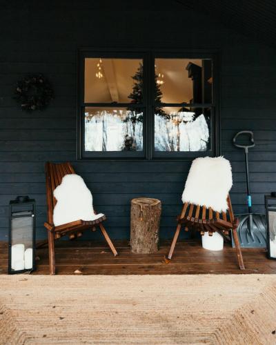 two chairs sitting on a deck in front of a house at Idyll Reserve - Hocking Hills in South Bloomingville
