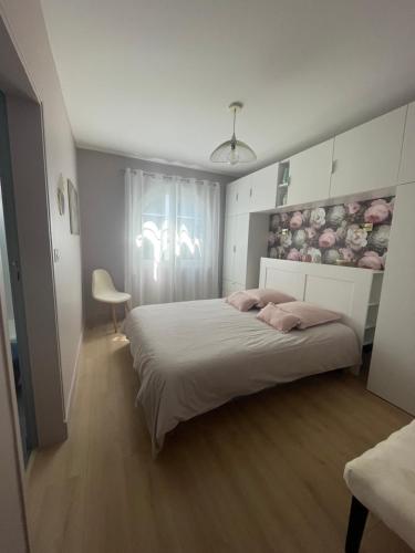 une chambre avec un grand lit et une fenêtre dans l'établissement Villa Fleurette Arcachon l aiguillon, à Arcachon