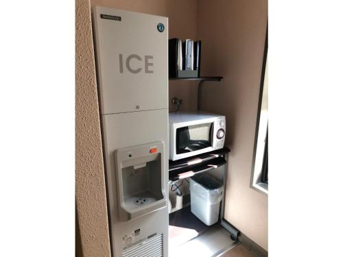 a small kitchen with a microwave and a toaster oven at Smile Hotel Tokyo Nishikasai - Vacation STAY 67938v in Tokyo