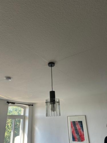 a chandelier hanging from a ceiling in a room at Gasthof zur Tanne in Alleringersleben