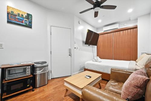 a living room with a couch and a bed at Heart of Downtown Delight in Philadelphia