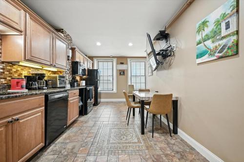 a kitchen with a table and chairs in it at Heart of Downtown Delight in Philadelphia