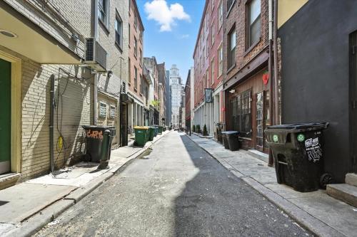 an empty alley with trash cans on a city street at Heart of Downtown Delight in Philadelphia
