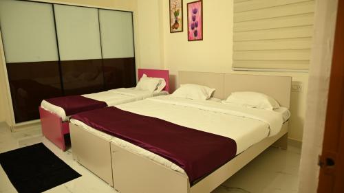 a bedroom with two beds in a room at RKN Home Stays in Warangal