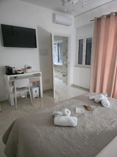 una camera da letto con un letto con asciugamani sopra di La Piuma Cagliari a Cagliari