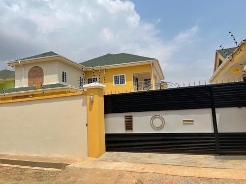 a house with a garage door in front of it at Dream Villa at Oyarifa in Oyarifa