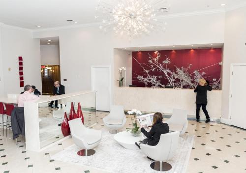 a lobby with people sitting in white chairs at The Point Hotel & Suites - 705H Luxury - Pool view - Close to Universal in Orlando