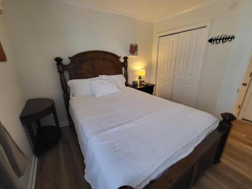 a bedroom with a large bed with white sheets at Steps To The Ocean! 129 in North Topsail Beach