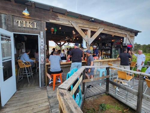 a group of people sitting at a bar at Steps To The Ocean! 129 in North Topsail Beach