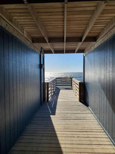 a boardwalk leading to the beach with the ocean in the background at Steps To The Ocean! 129 in North Topsail Beach